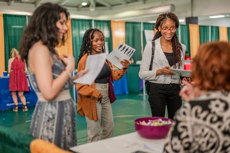 Students meet with an employer at a career fair