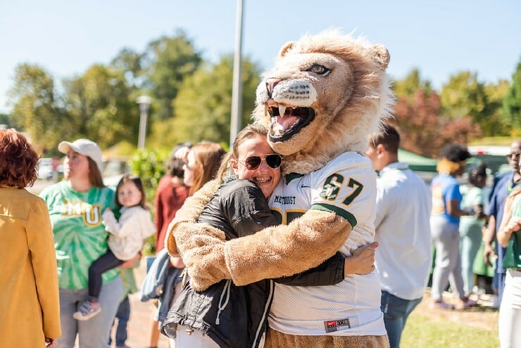 Mascot King embraces a student