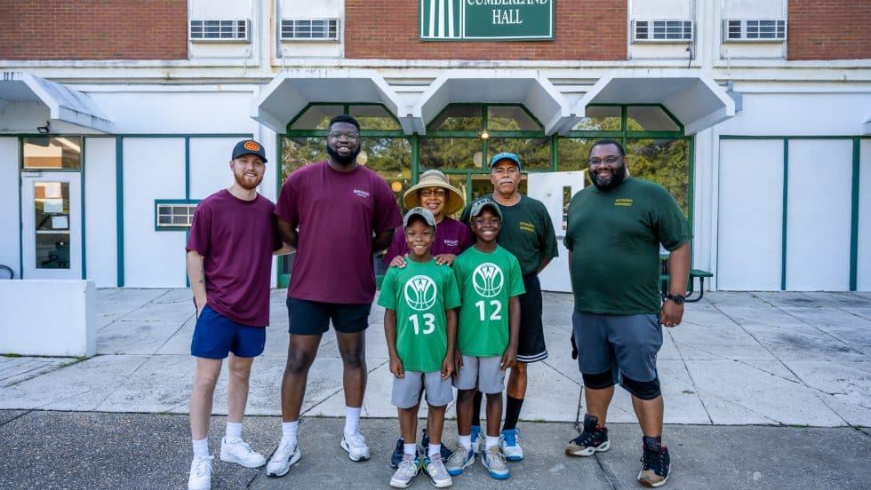 A family poses outside Cumberland Hall