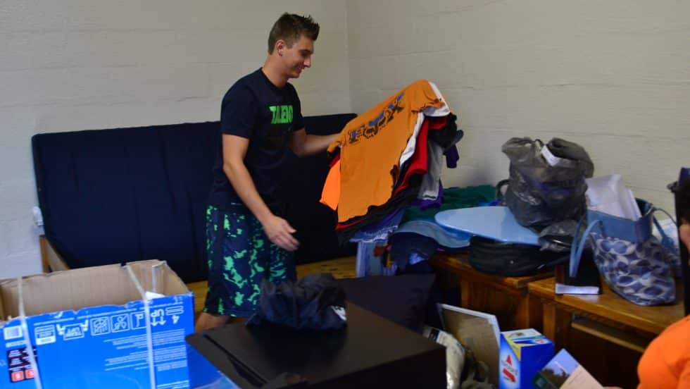 A student unpacks in his room at Cumberland Hall