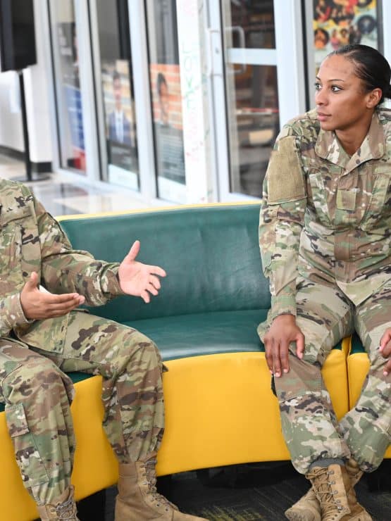 Students in military uniforms are engaged in a conversation