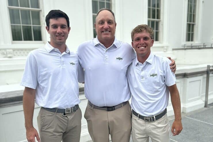 Methodist University Golf national champions (l-r) Chase Walts, Coach Steve Conley, and Caleb Ryan pose at the White House in Washington, D.C. on Monday prior to being honored for their 14th title by Vice President Kamala Harris and others.