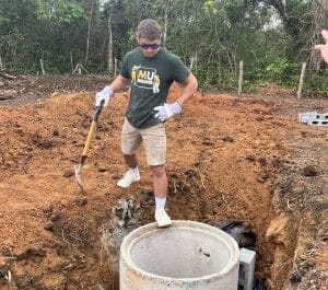 Mission trip participant digs a well