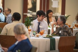 A student and a donor talk over lunch