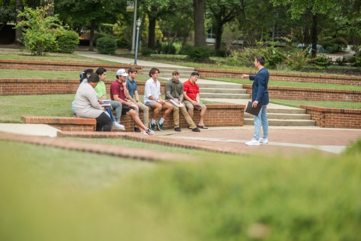 Dr. Christopher Cronin leads a Political Science class outdoors