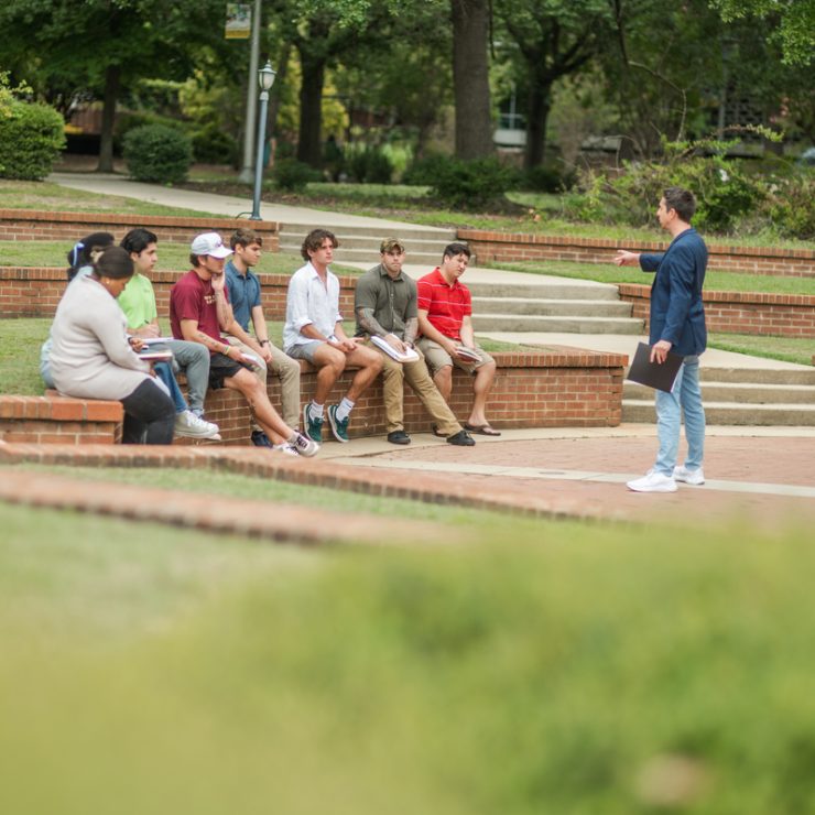 Dr. Christopher Cronin leads a Political Science class outdoors