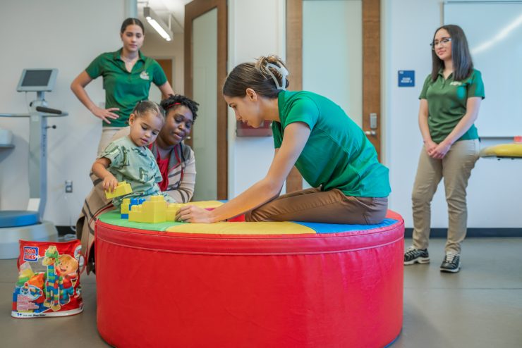 Occupational Therapy students work with child and parent