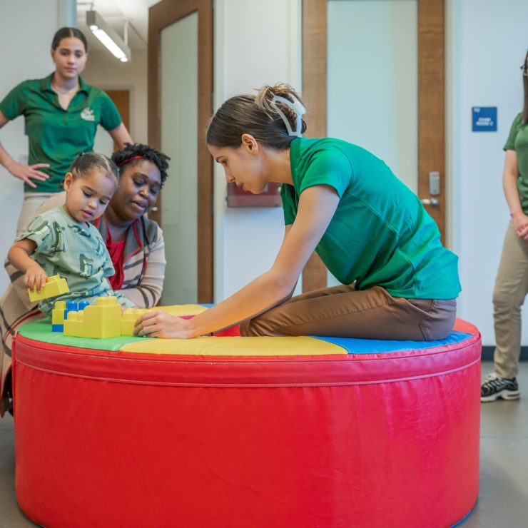 Occupational Therapy students work with child and parent